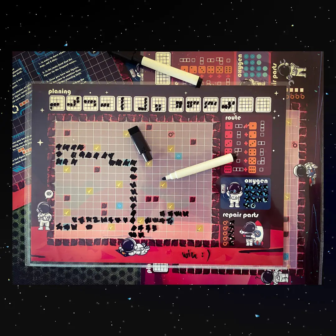 A photo of the "Micro Mars" Roll&Write game map with a marker pen, showing how players use the sheet and pen during gameplay.print and play game fernflowerpress.com 